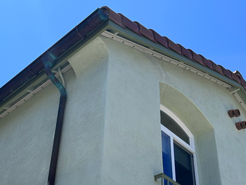 White low-profile track mounted along underside of eaves